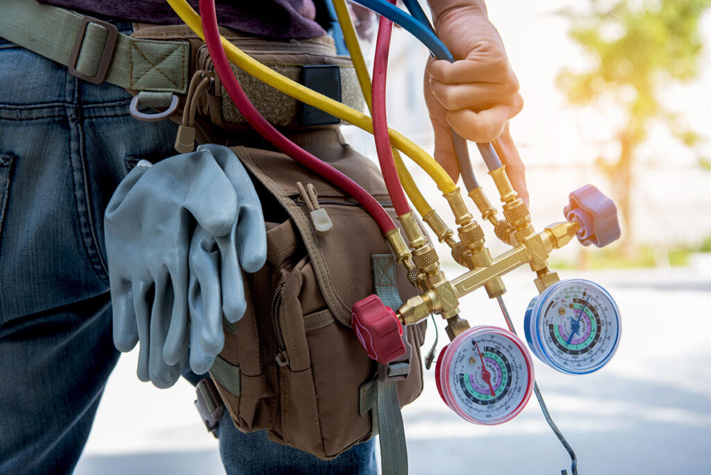 man in hvac holding equipment