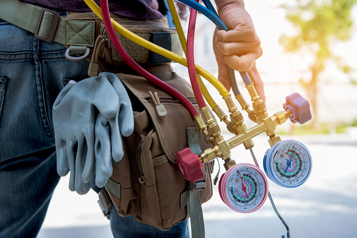 man in hvac holding equipment